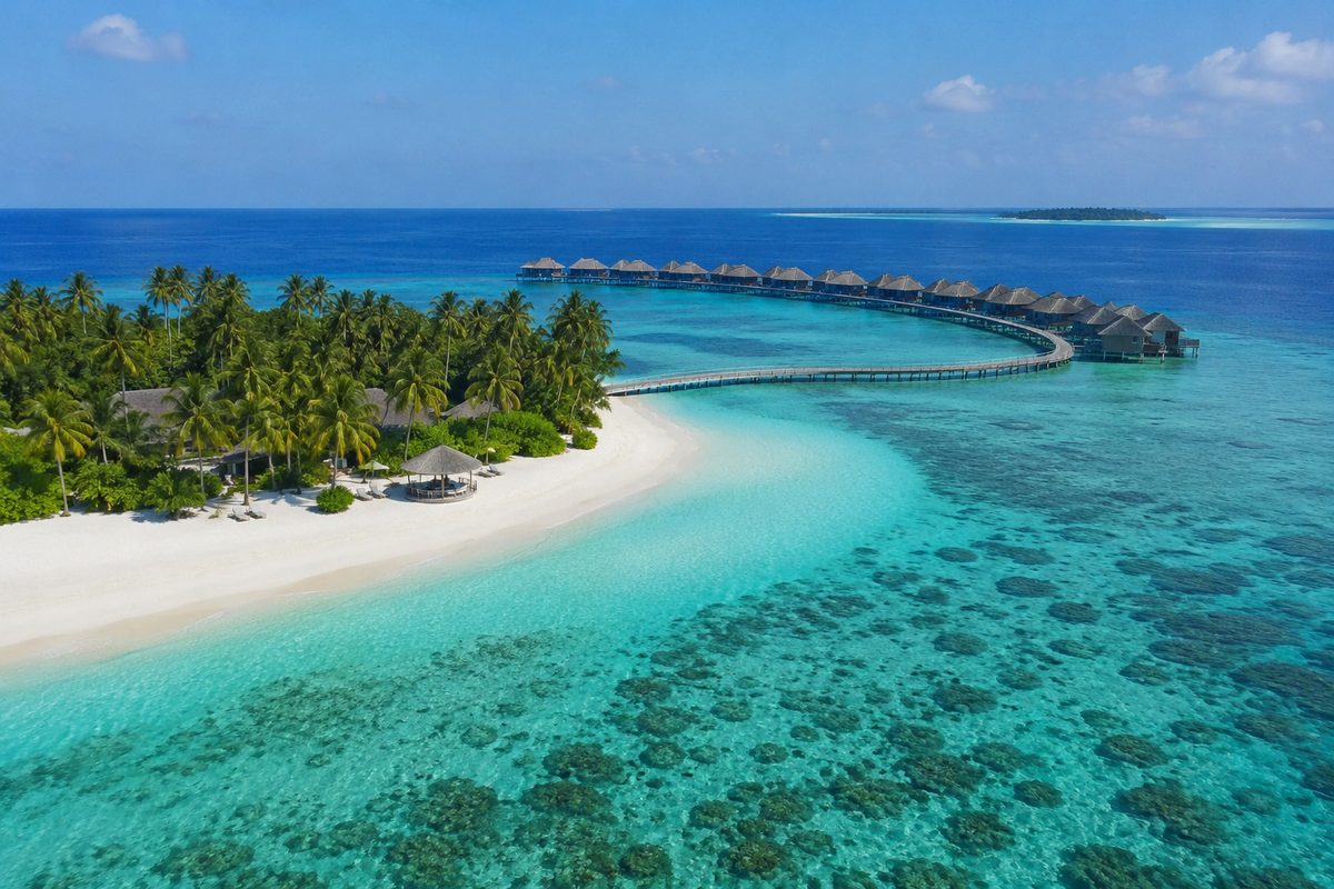 Maldives island with a turquoise lagoon, white sand and overwater villas