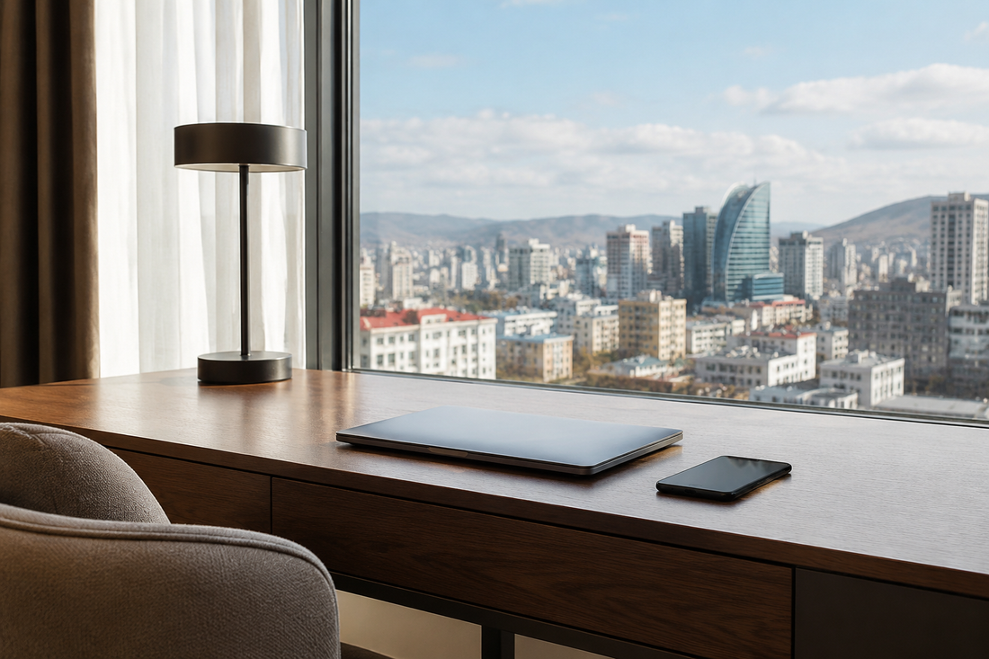 Phone and laptop in a modern hotel with an Ulaanbaatar-inspired city view