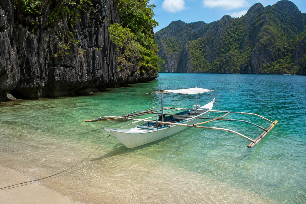 Philippine-style outrigger boat beside limestone islands in turquoise water