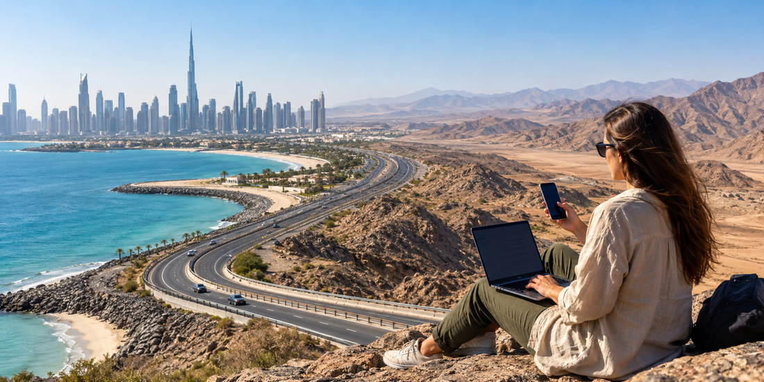 Traveller using phone and laptop across UAE city, coast and mountain scenery